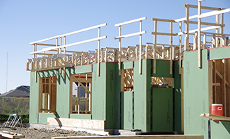 Building with exposed trusses and wall insulation